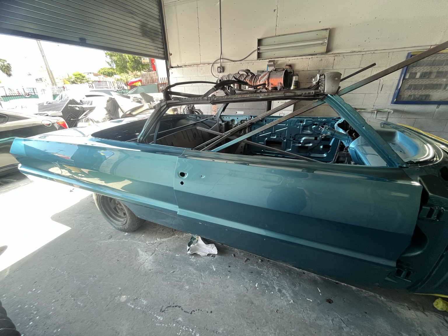 Teal classic vehicle body during restoration work
