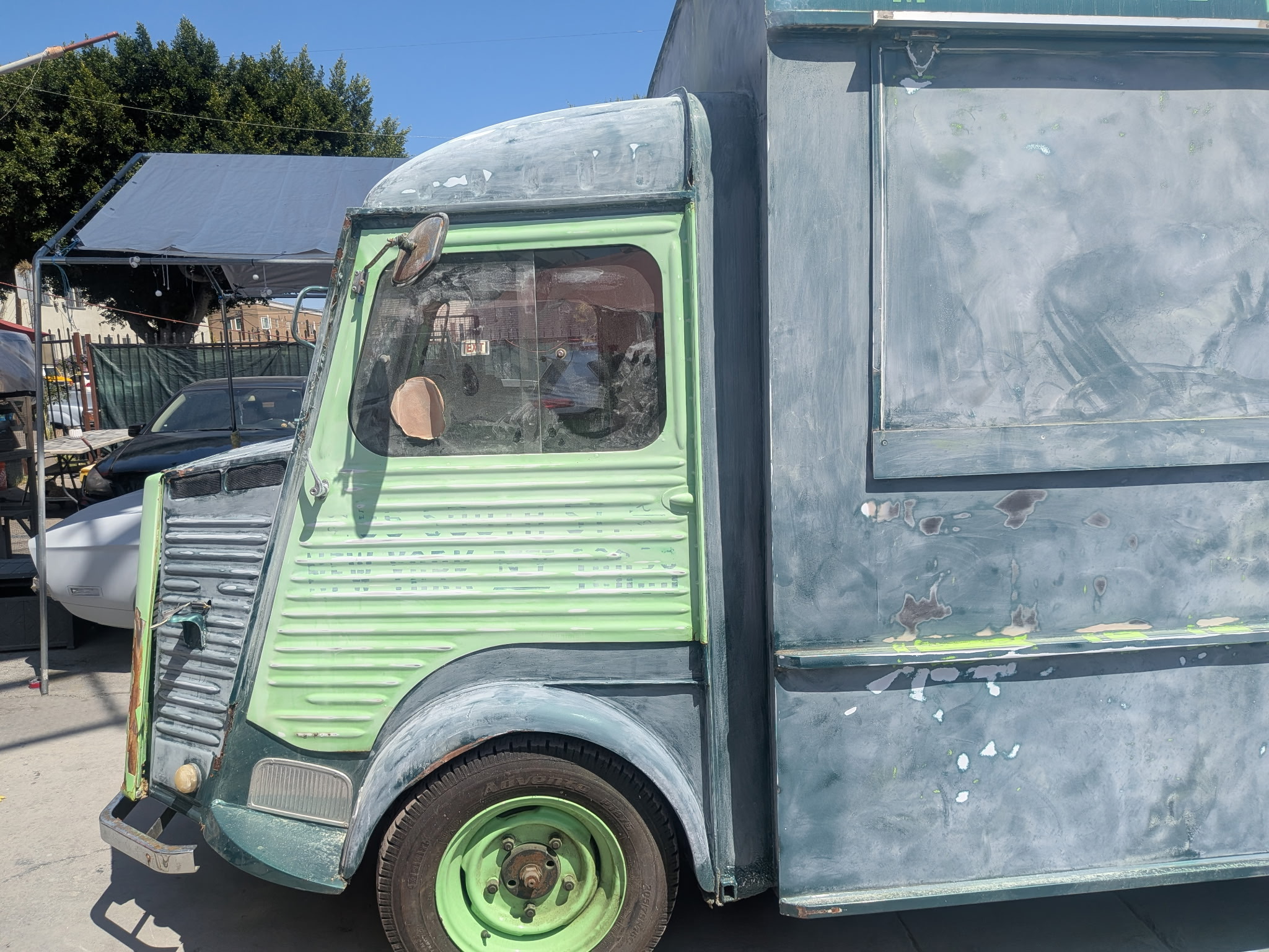 Vintage van with green paint and prepared body panels before refinishing